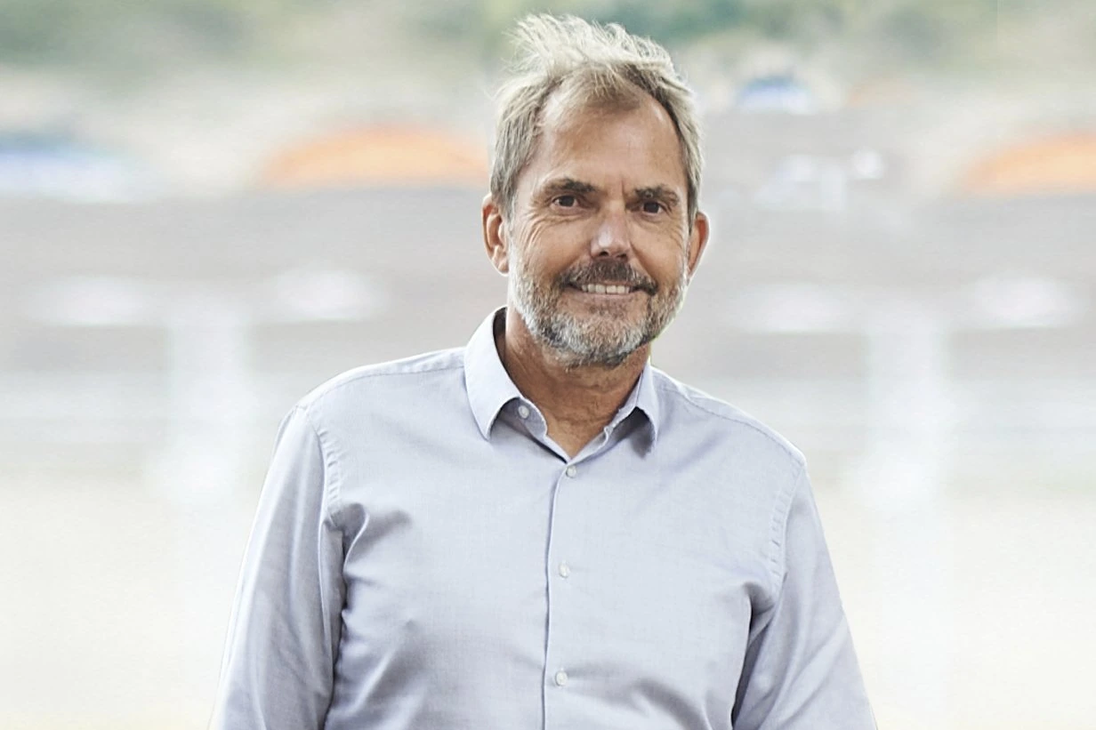 Portrait photo of Jeremy Middleton smiling in a light shirt